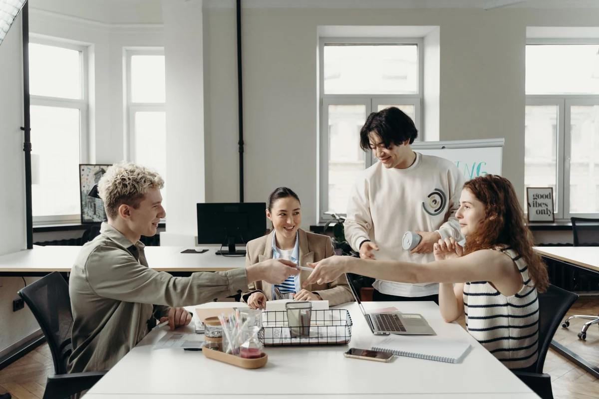 Team members collaborating around a table in a bright modern office